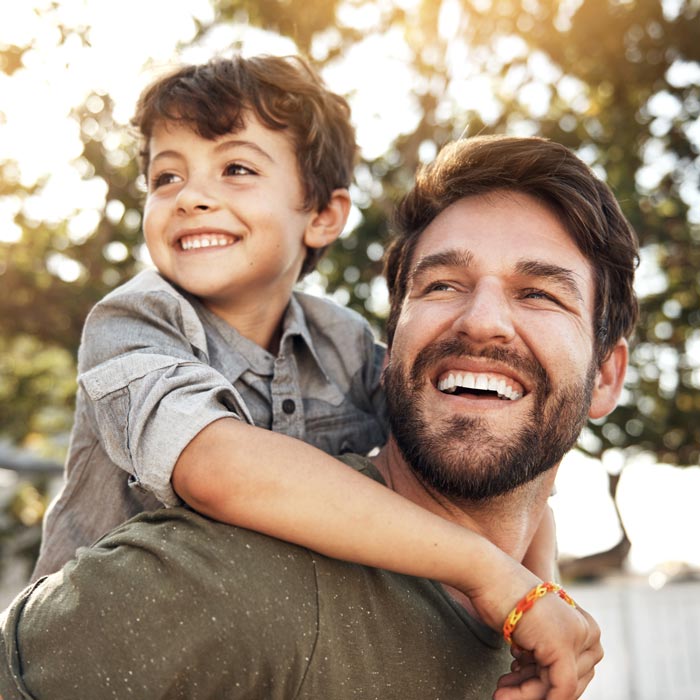 father and son smiling