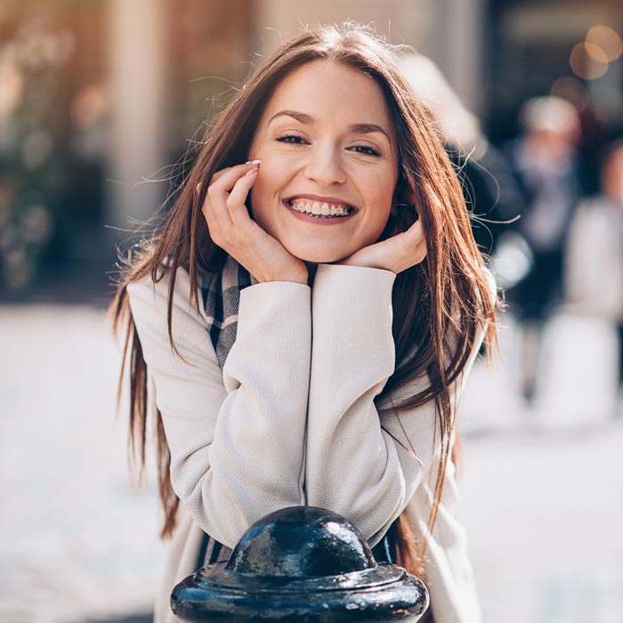 woman with clear braces smiling